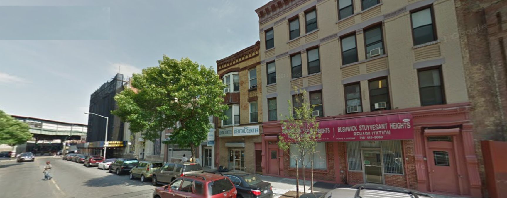 1010 Gates, the middle house, still a "tan brick house with the chocolate colored cornice and the ornamental trim."