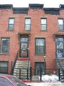 598 Hancock Street as it looks today. One of four lookalike row houses in the middle of the block.